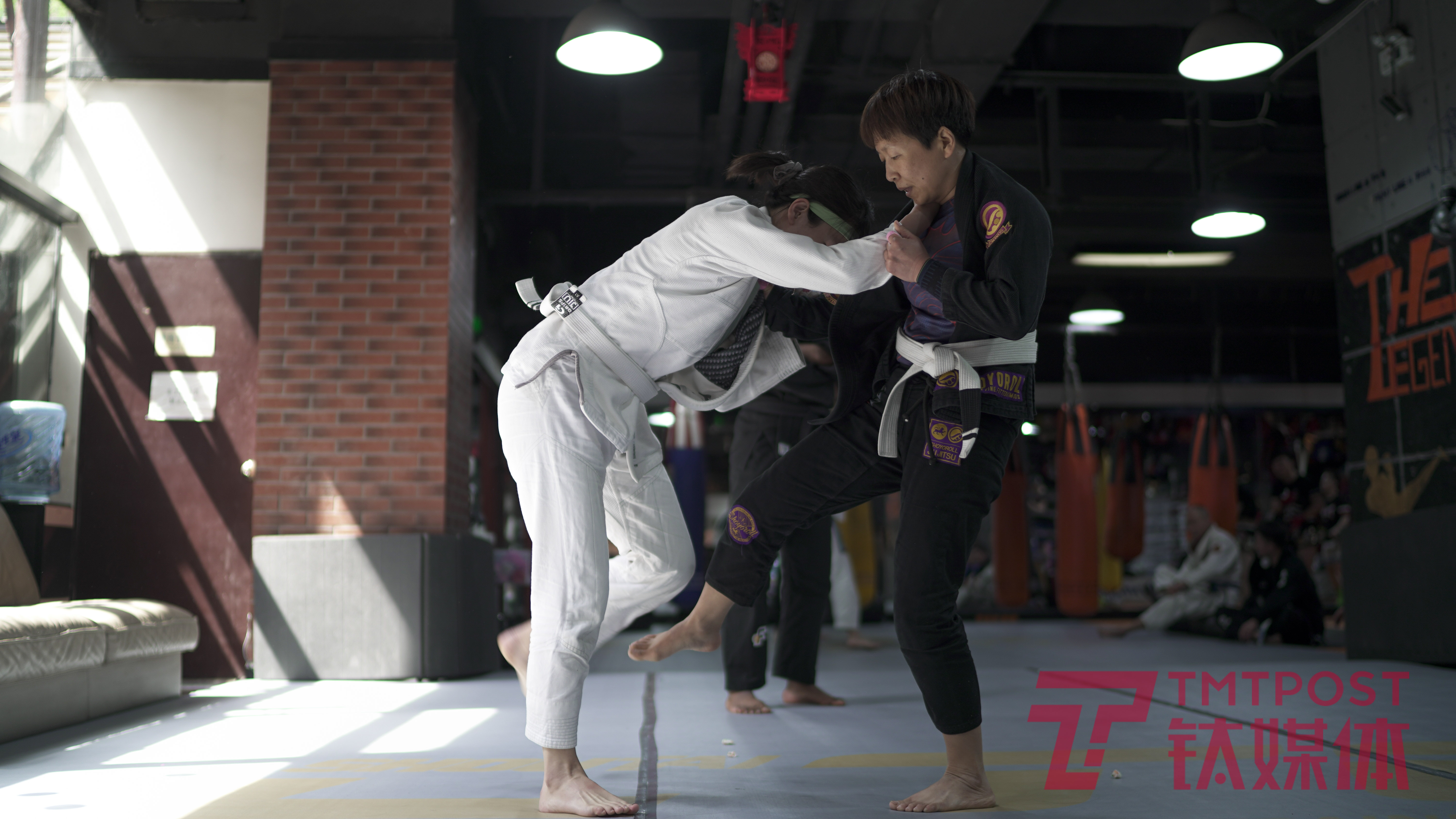 Pan Jie practicing Brazilian jiu-jitsu with a partner