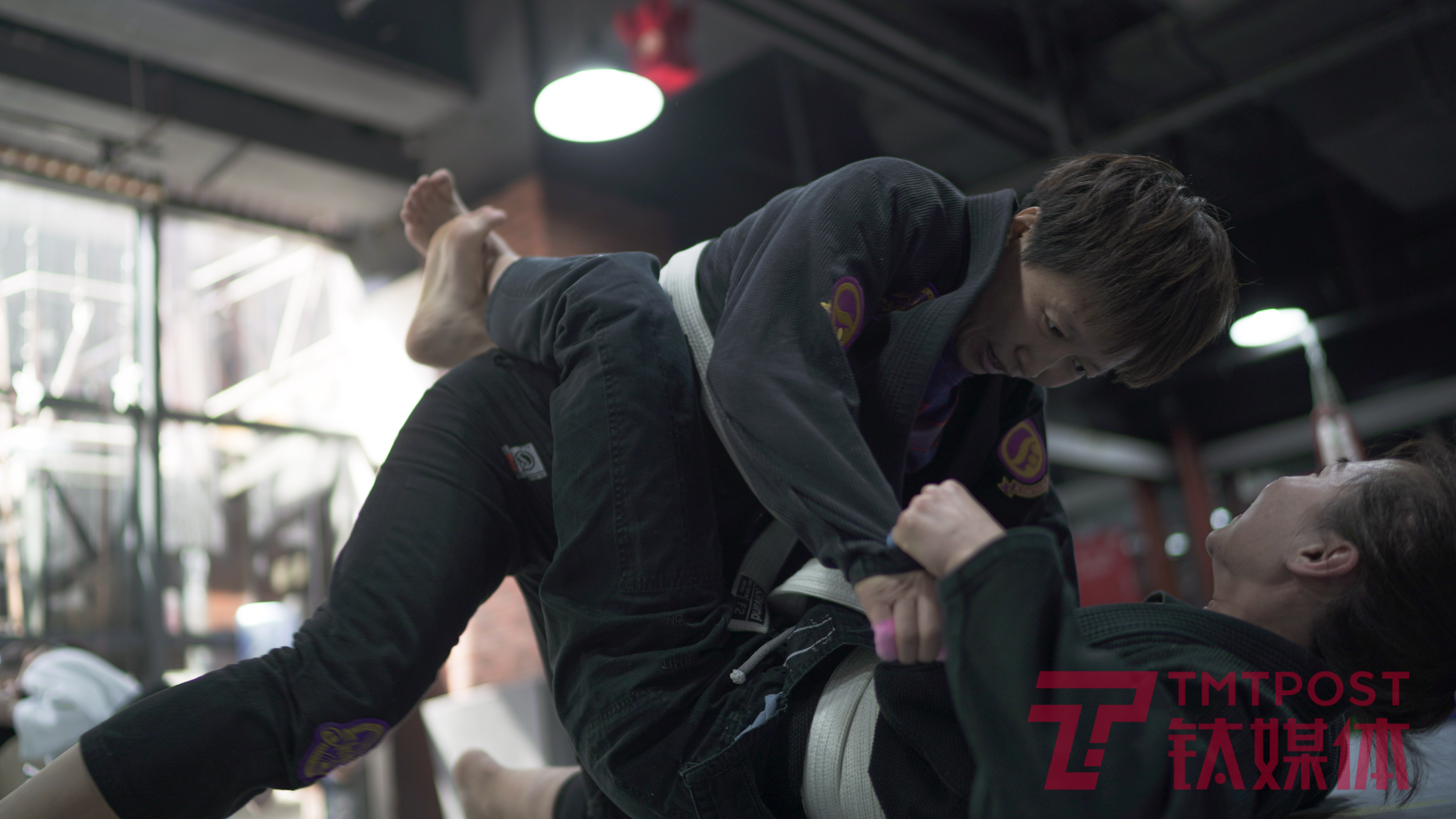 Pan Jie practicing Brazilian jiu-jitsu with a partner