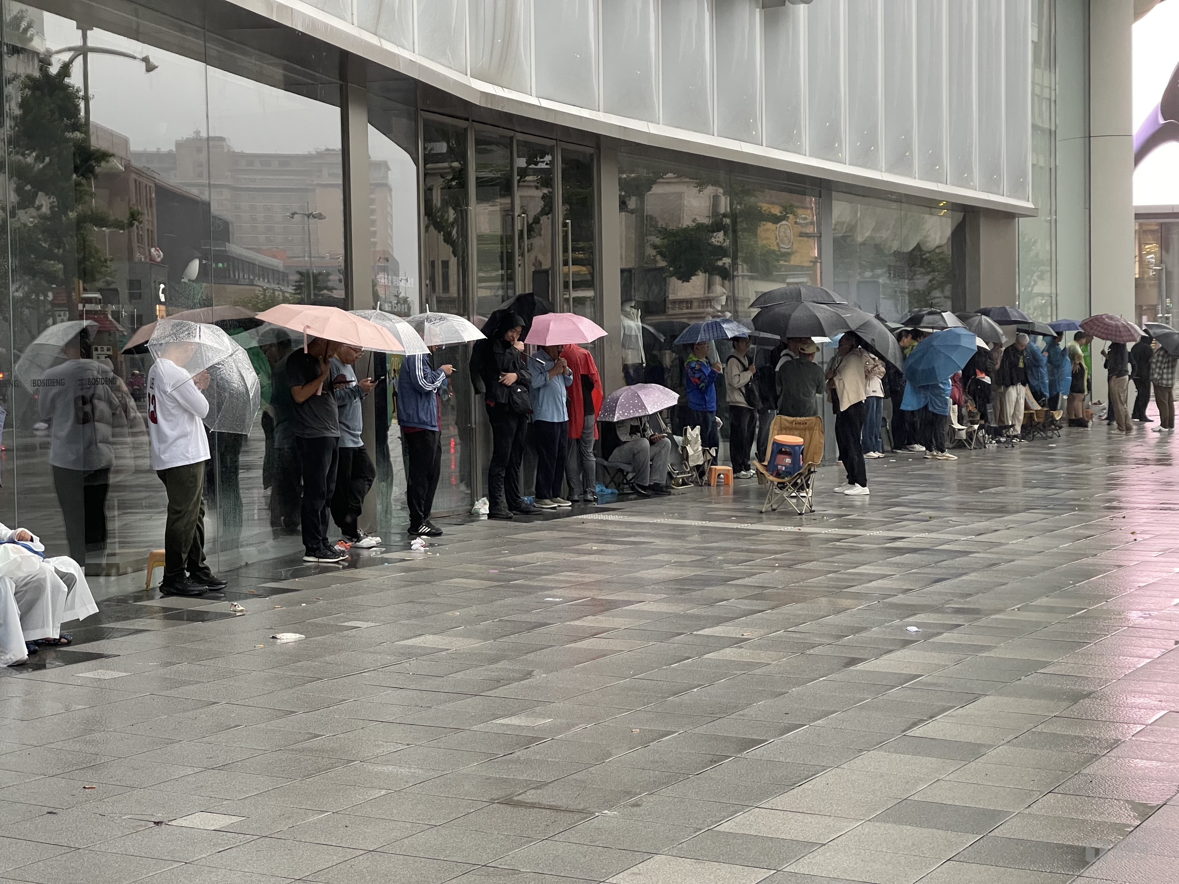 华为店门口熬夜淋雨排队的人，钛媒体APP拍摄